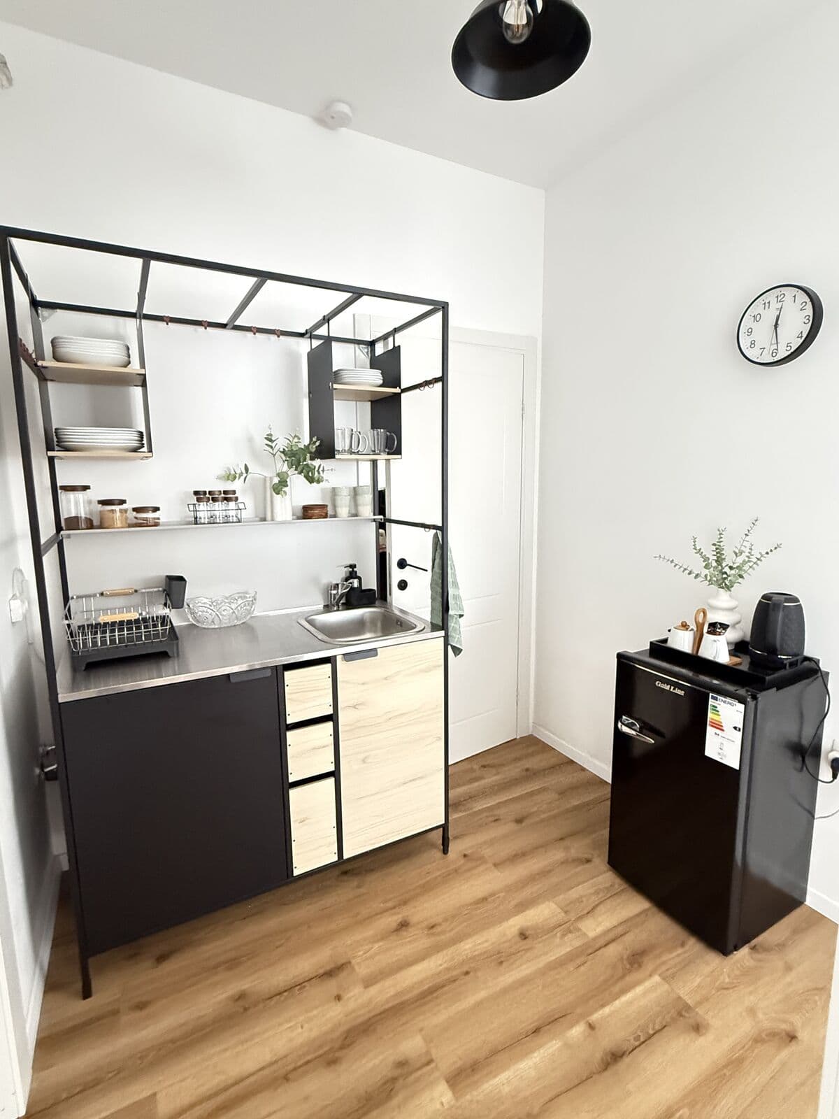 Studio kitchenette: mini fridge, kettle, and microwave